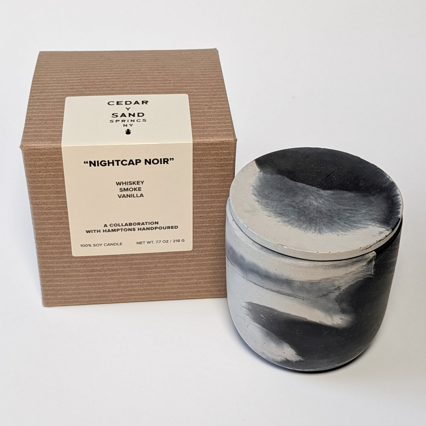 Product shot of Nightcap Noir candle and box on white background with branding label.
