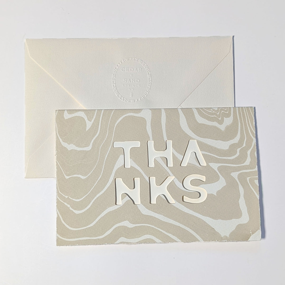 CEDAR Y SAND Thanks Notecard in Oat, featuring natural Suminagashi marbling, cut-out THANKS lettering and embossed envelope.