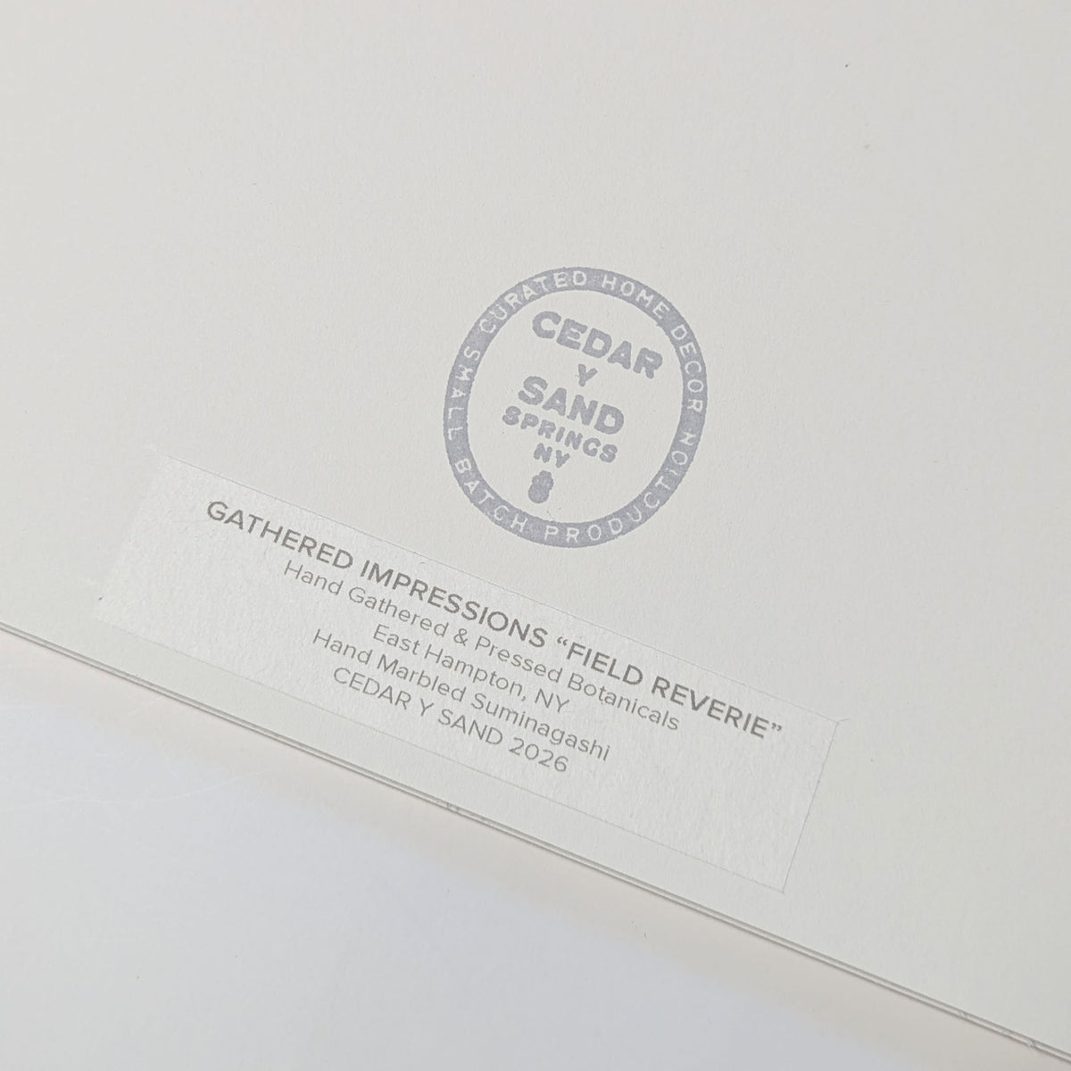 Reverse of Field Reverie artwork showing the CEDAR Y SAND studio stamp and Gathered Impressions label documenting hand-gathered East Hampton botanicals and Suminagashi.
