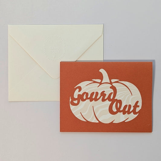 Hand-cut pumpkin Gourd Out notecard with marbled paper backing, paired with embossed cream envelope on neutral background.