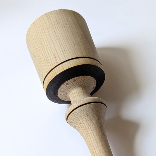 Close-up of Hernán machacador’s natural wood grain and burn detail