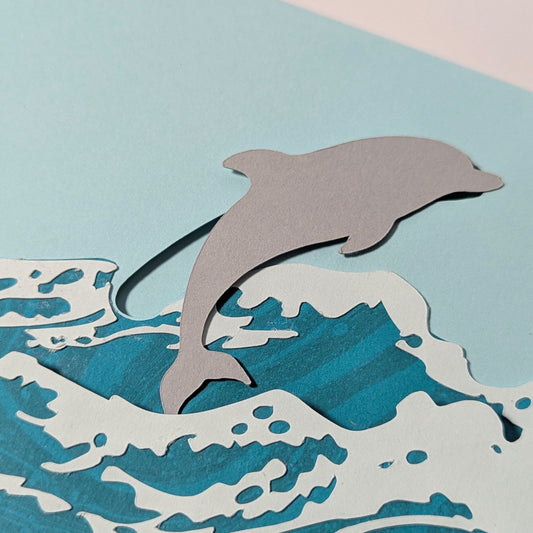 Close-up of Surfin’ Flipper notecard showing cut-paper dolphin slider detail.