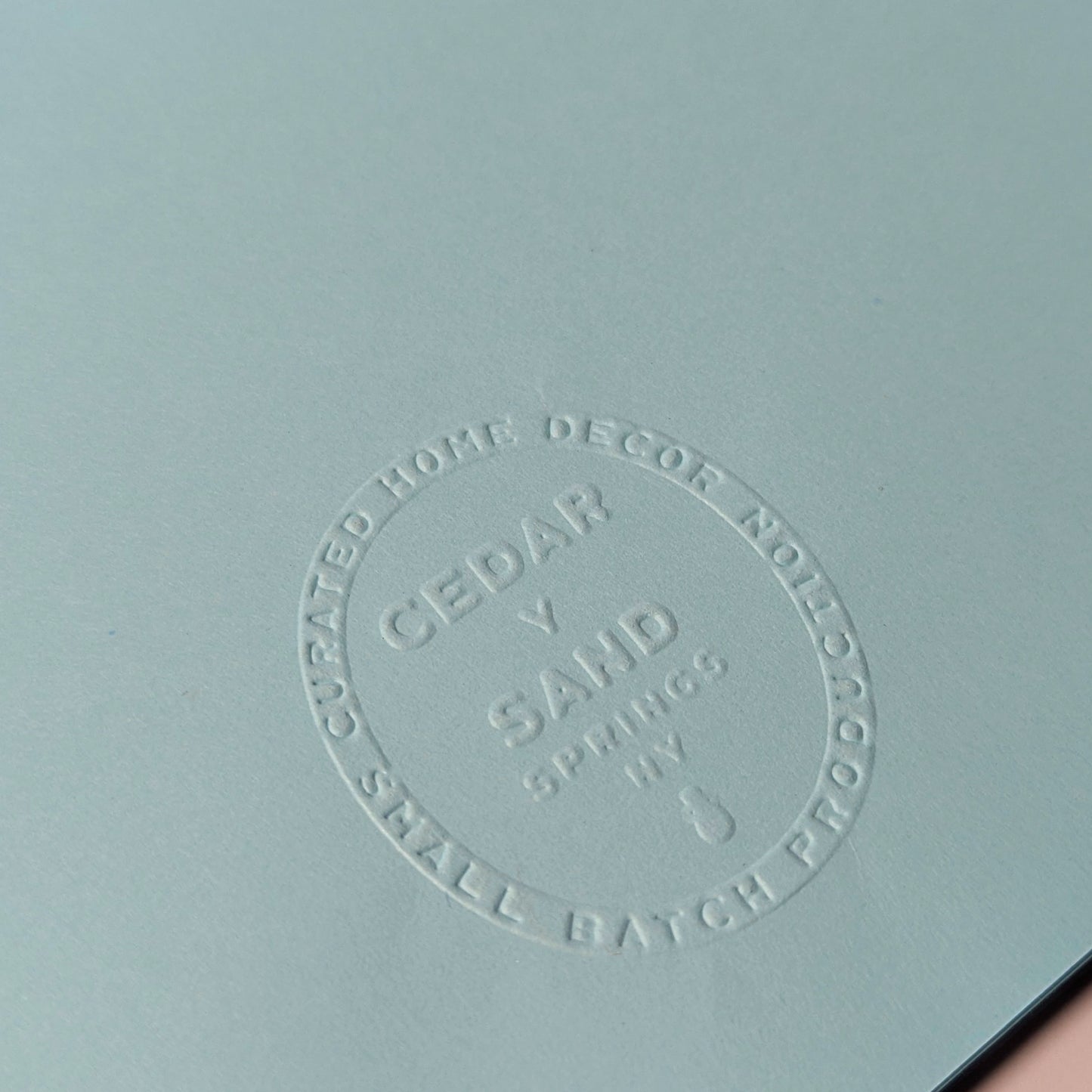 Embossed Cedar Y Sand insignia on back of Surfin’ Flipper notecard.