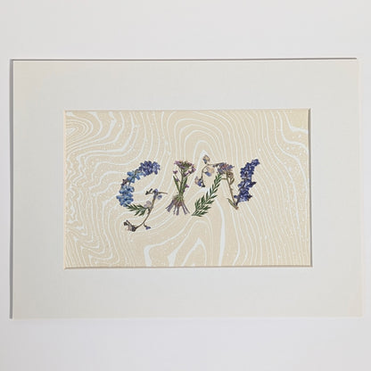 Pressed floral word “GIN” made with pressed botanicals on Suminagashi marbled paper, unique handmade word artwork