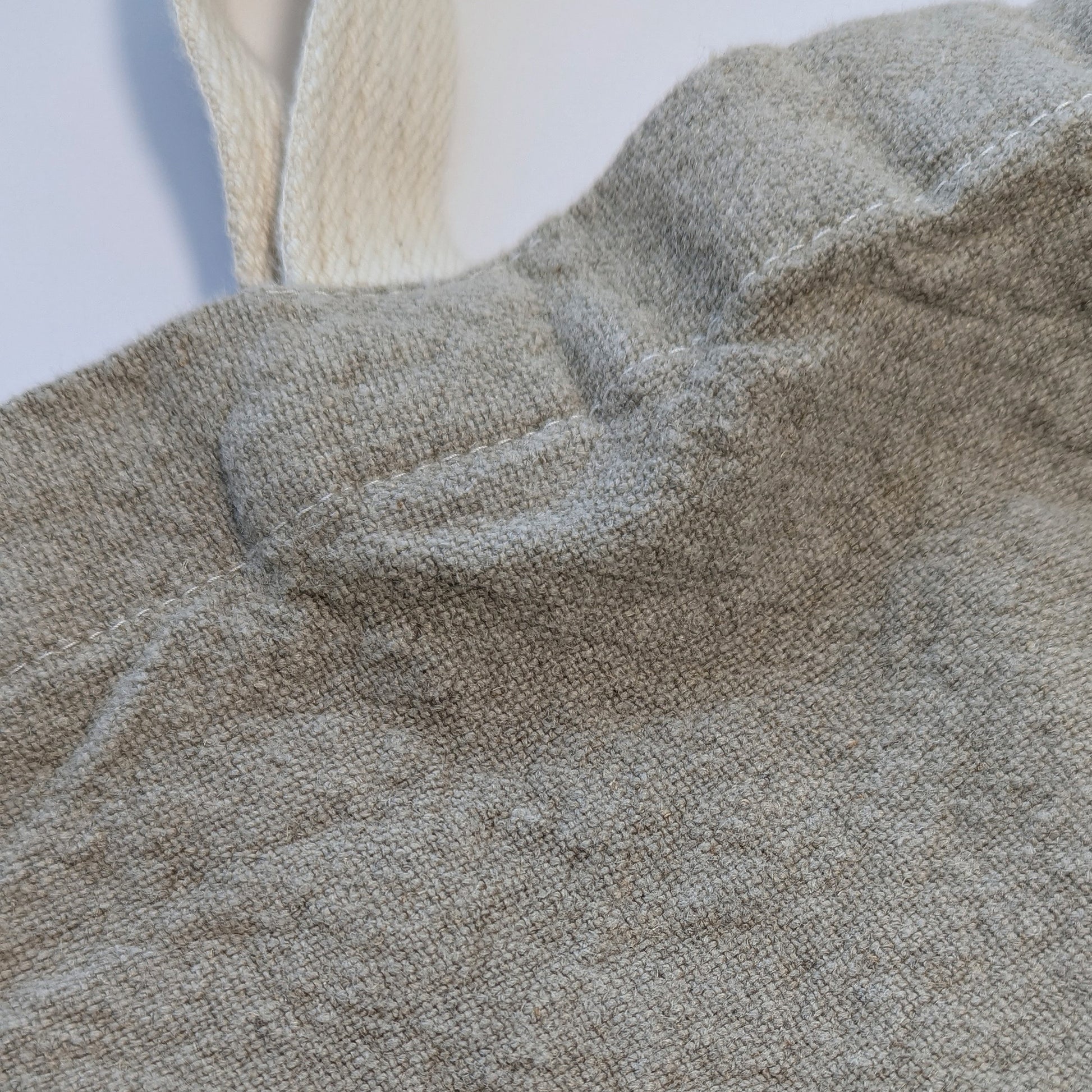 Detail of textured stone-washed linen fabric and cotton webbing handle on Doudou tote