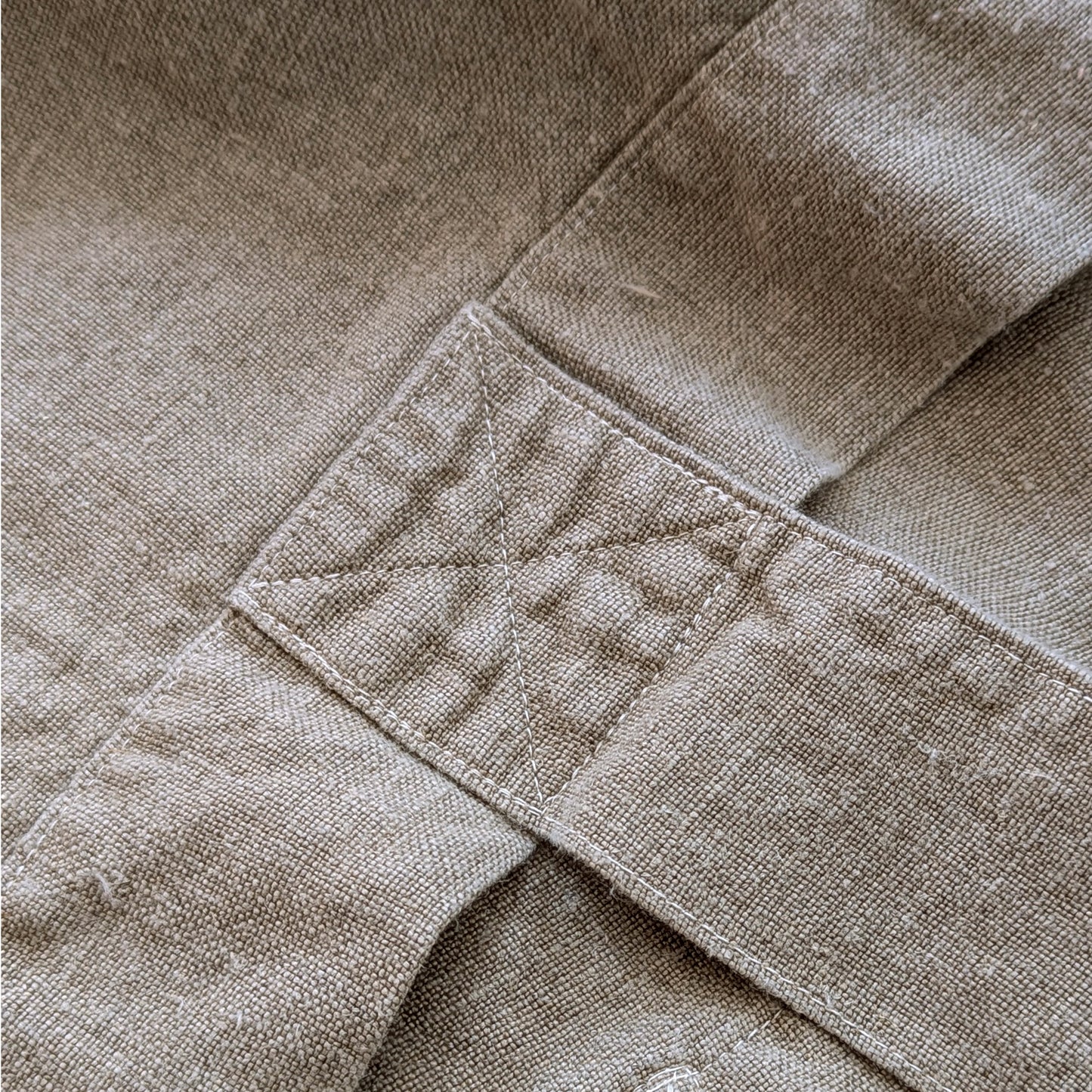 Close-up detail of reinforced stitching on natural linen Escapade tote handle attachment