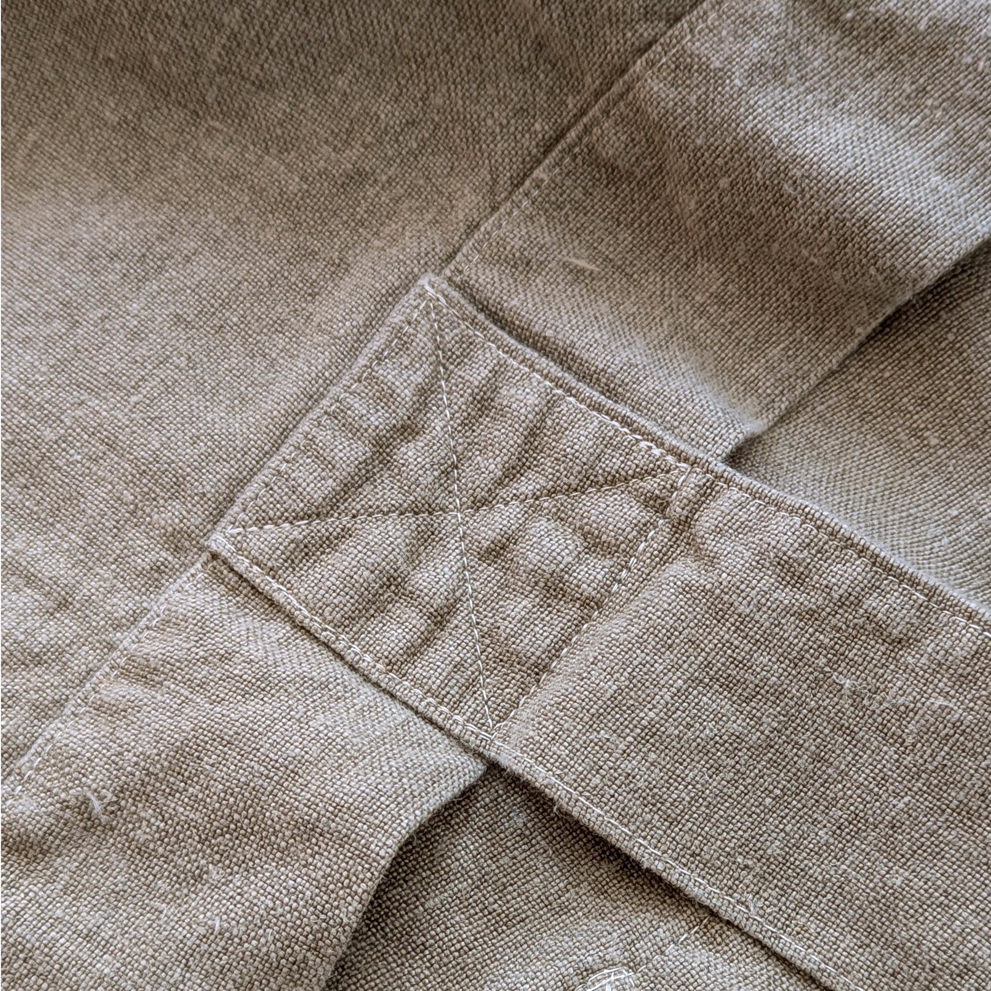 Close-up detail of reinforced stitching on natural linen Escapade tote handle attachment