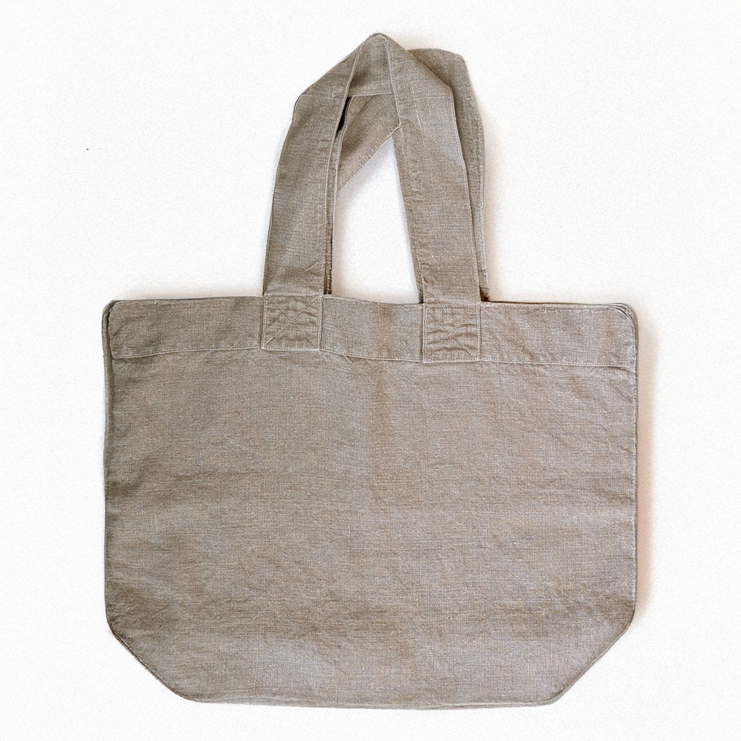 Natural linen Escapade tote bag by Charvet Éditions shown flat front view with wide handles