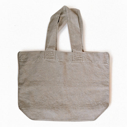 Natural linen Escapade tote bag by Charvet Éditions shown flat front view with wide handles