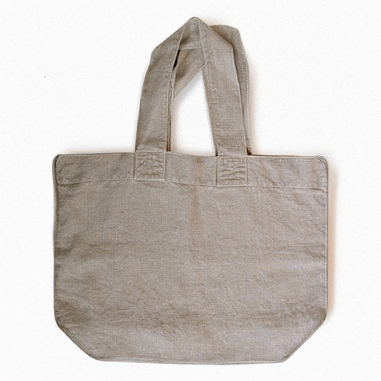 Natural linen Escapade tote bag by Charvet Éditions shown flat front view with wide handles