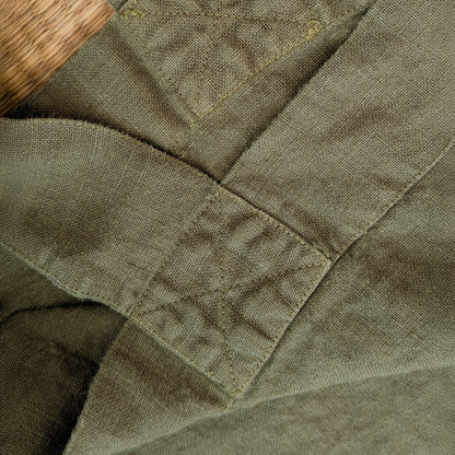 Close-up detail of reinforced stitching on olive linen Escapade tote handle attachment