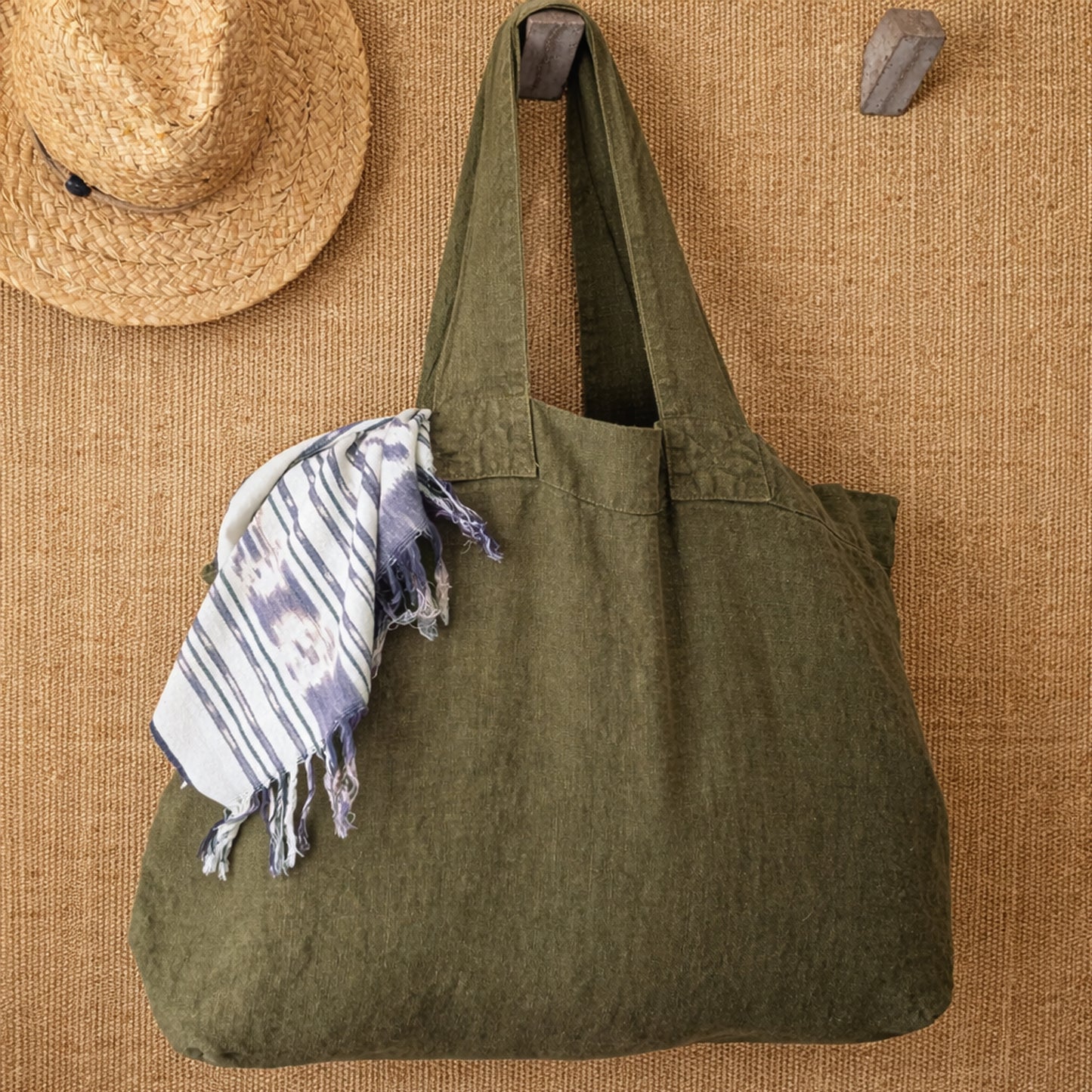 Olive linen Escapade tote styled with woven textures and scarf in warm neutral interior