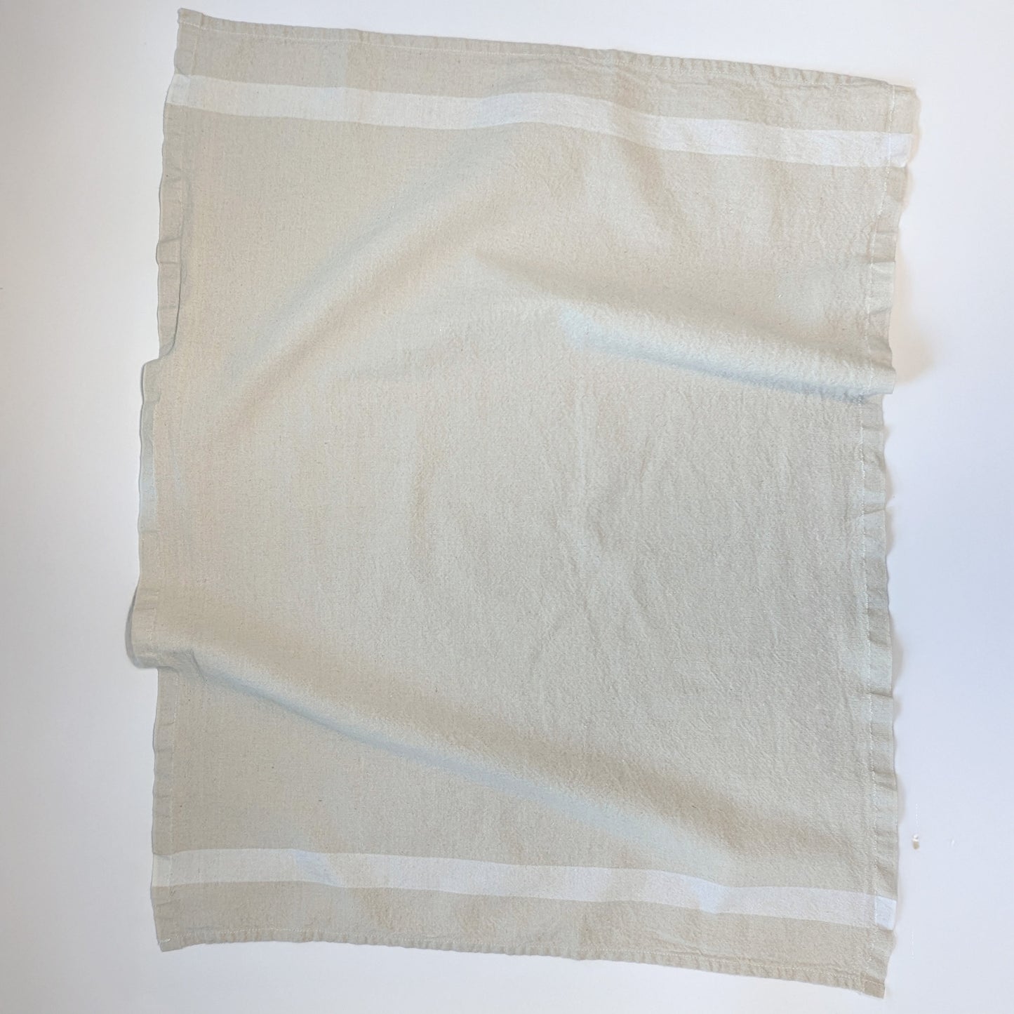 Charvet Éditions Phenix kitchen towel in Natural colorway laid flat with subtle white woven stripe