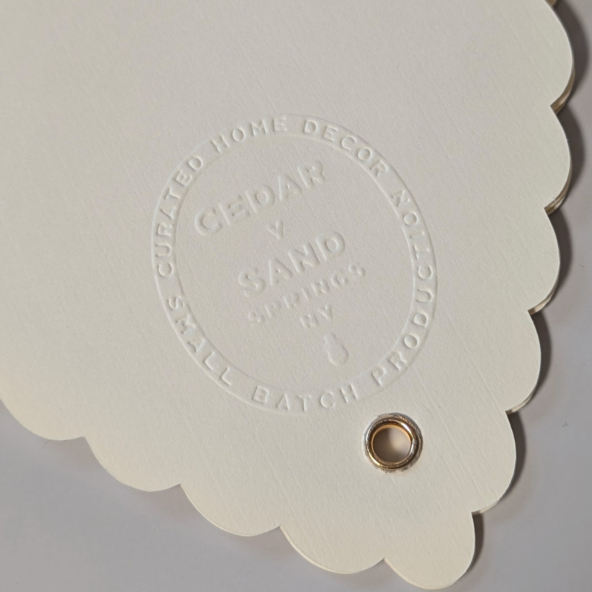 Embossed Cedar y Sand insignia on the reverse of heart notecard