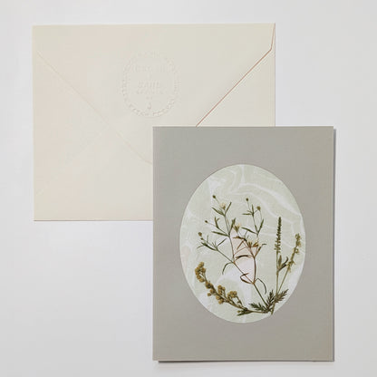 Handmade Suminagashi notecard with pressed meadow sprigs, featuring delicate wild stems on soft marbled Hosho paper with embossed envelope