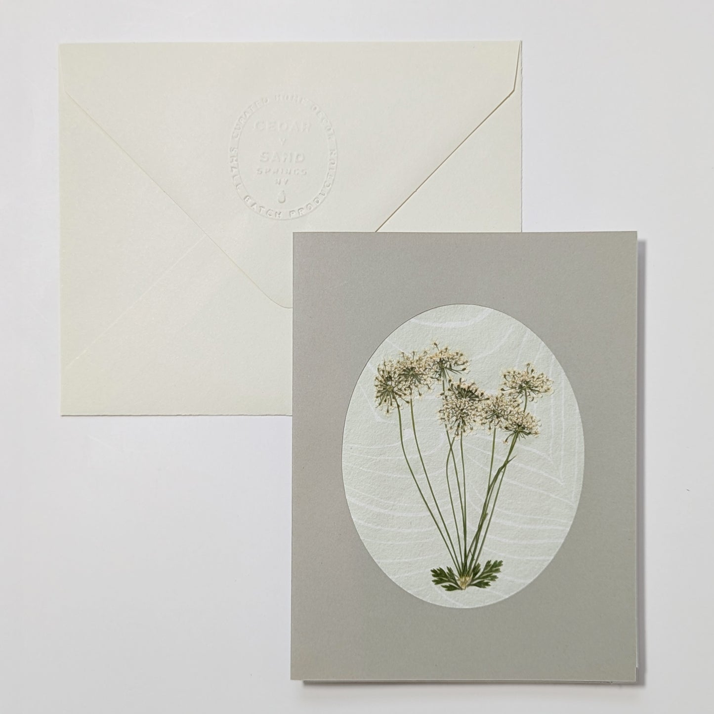Handmade Suminagashi notecard featuring pressed wild meadow blooms on marbled Hosho paper with embossed envelope