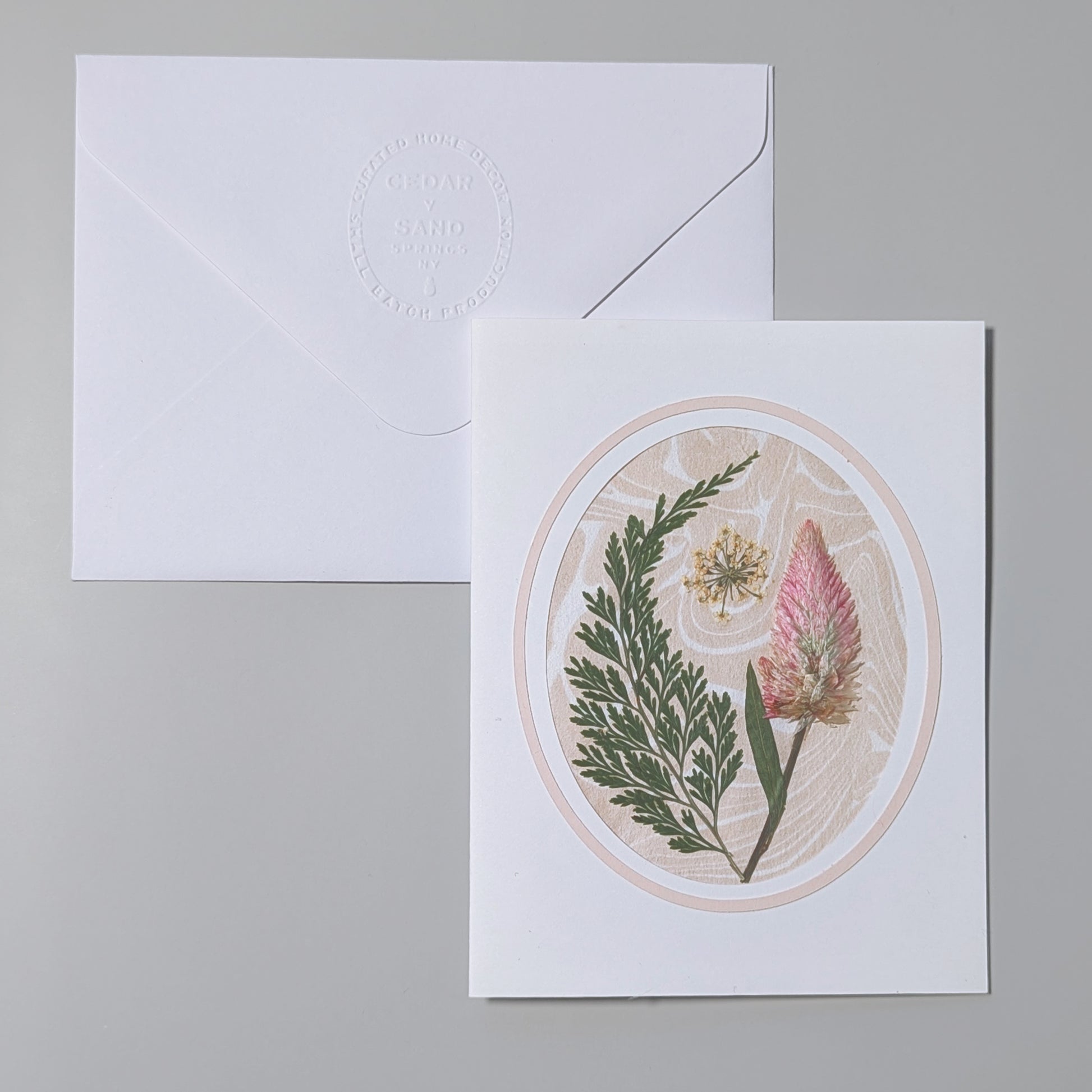 Handmade Suminagashi pressed flora notecard with blush wildflower, greenery, and cameo oval frame on marbled Hosho paper with embossed envelope
