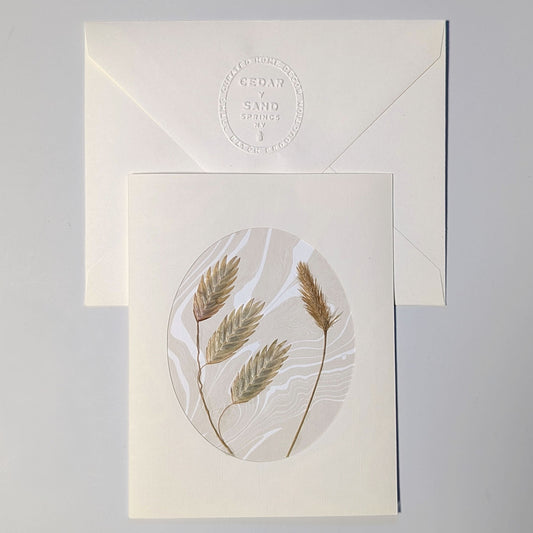 Walking Dunes Oat Grass handmade Suminagashi notecard featuring pressed golden grasses on neutral marbled paper with embossed CEDAR Y SAND envelope.