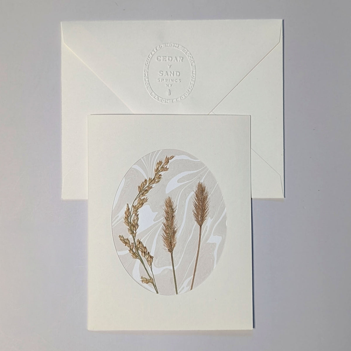Walking Dunes Straw handmade Suminagashi notecard featuring pressed golden grasses on neutral marbled paper with embossed CEDAR Y SAND envelope.