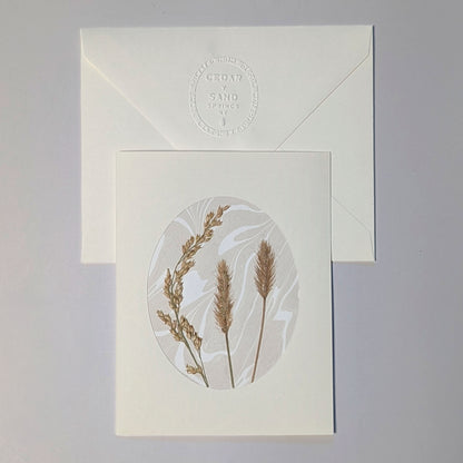 Walking Dunes Straw handmade Suminagashi notecard featuring pressed golden grasses on neutral marbled paper with embossed CEDAR Y SAND envelope.