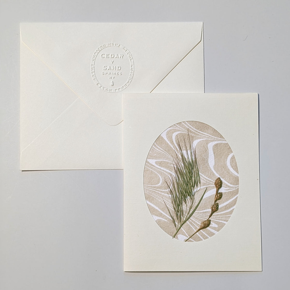 Walking Dunes Wisp handmade notecard featuring fine pressed grasses and small seed heads over warm neutral hand-marbled Suminagashi paper.