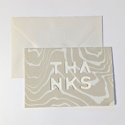 CEDAR Y SAND Thanks Notecard in Oat, featuring natural Suminagashi marbling, cut-out THANKS lettering and embossed envelope.