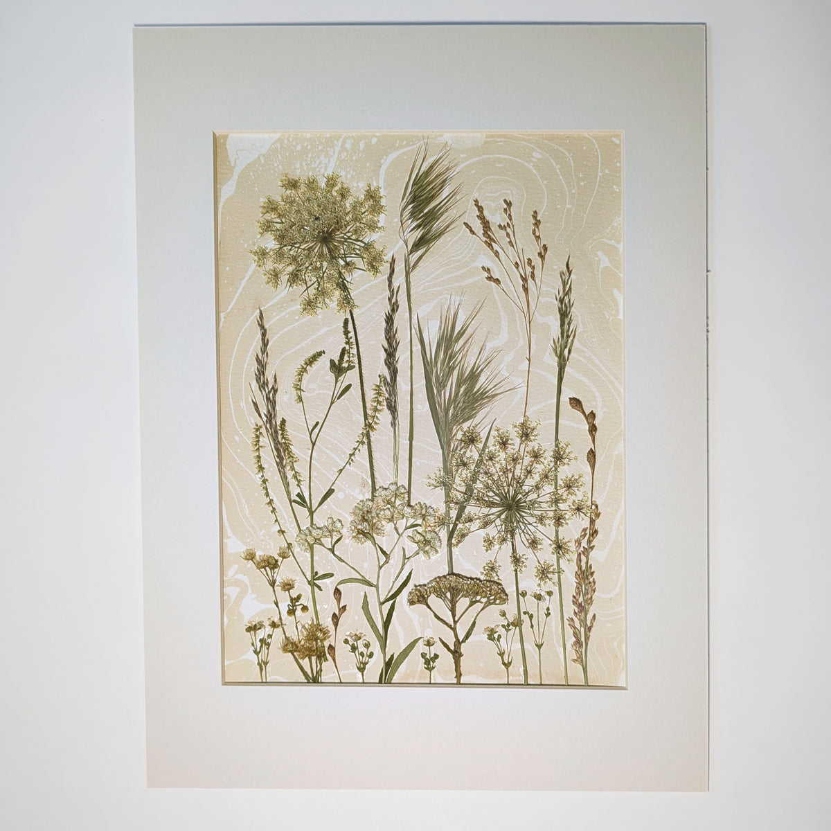 Late Meadow one-of-a-kind pressed botanical composition with East Hampton grasses, seed heads and wild flora over warm neutral Suminagashi, matted 12 x 16 inches.