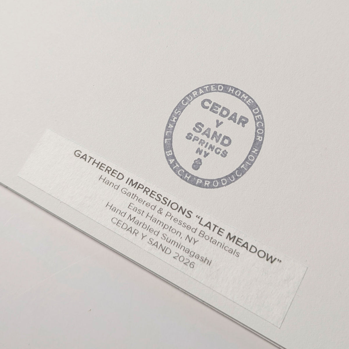 Back of Late Meadow with CEDAR Y SAND studio stamp and Gathered Impressions label identifying hand-gathered and pressed East Hampton botanicals.