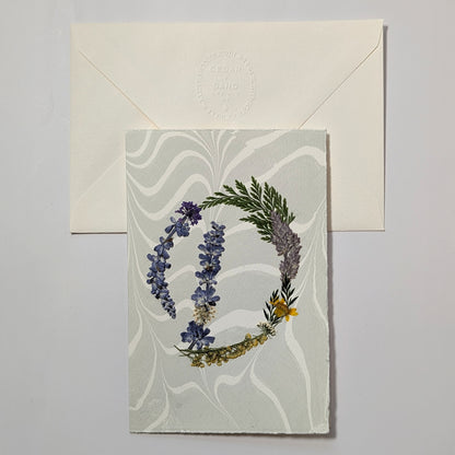 Pressed botanical letter D notecard on soft blue marbled paper with envelope, handmade floral initial card