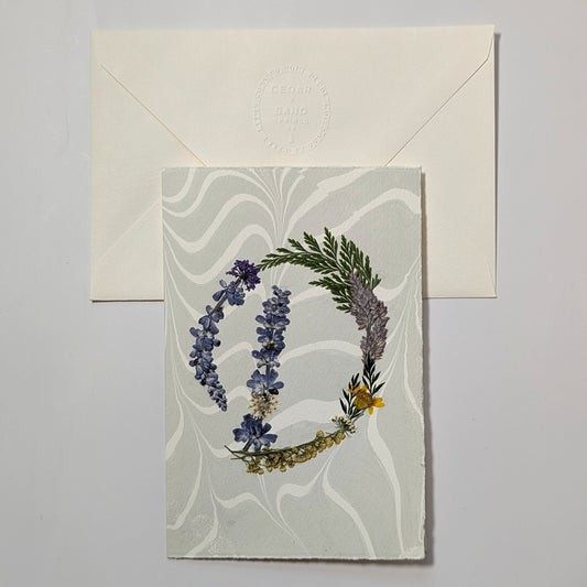 Pressed botanical letter D notecard on soft blue marbled paper with envelope, handmade floral initial card