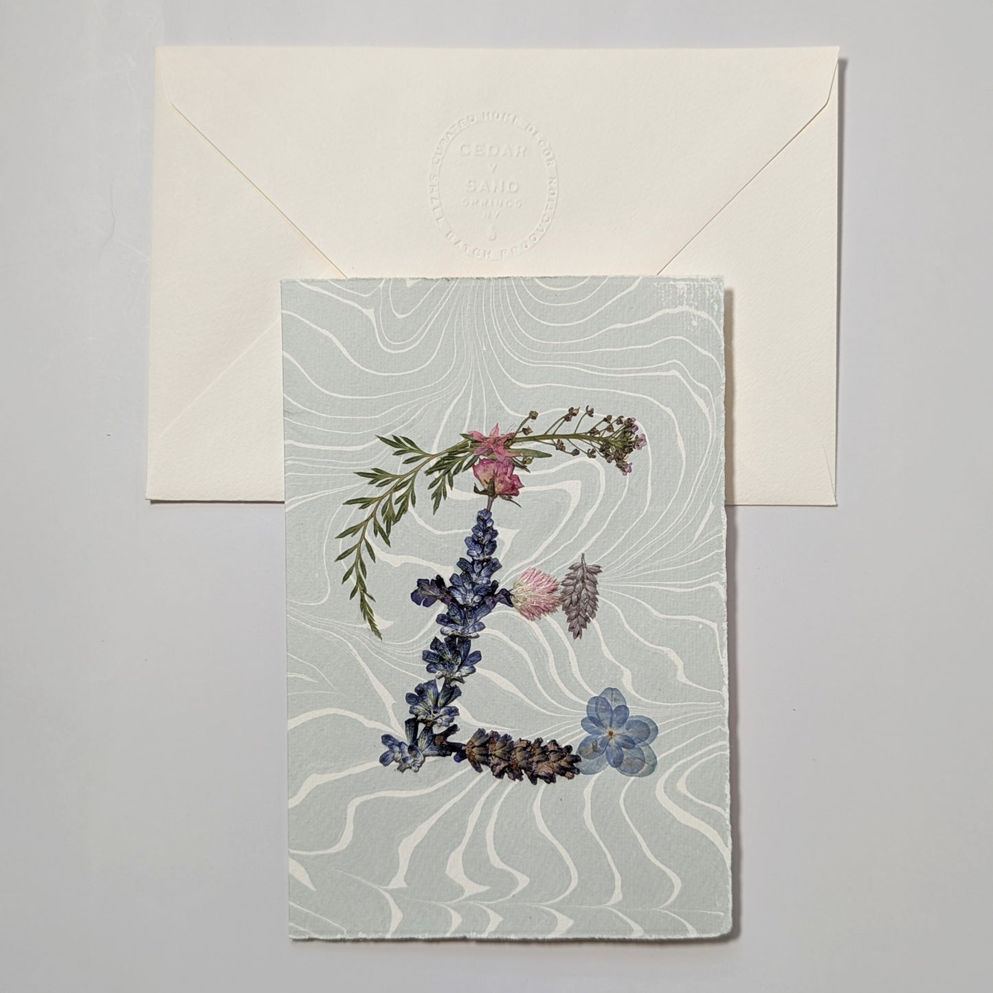 Pressed flower letter E notecard on soft blue Suminagashi paper with envelope, handmade botanical letter card