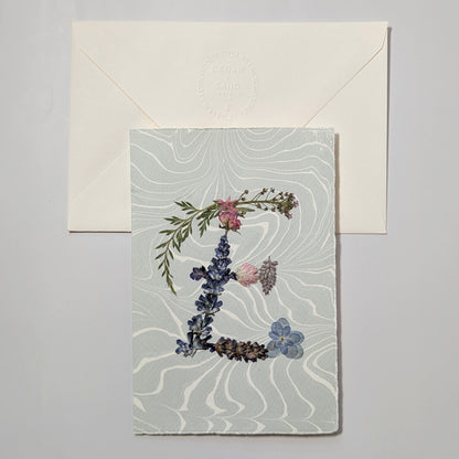 Pressed flower letter E notecard on soft blue Suminagashi paper with envelope, handmade botanical letter card