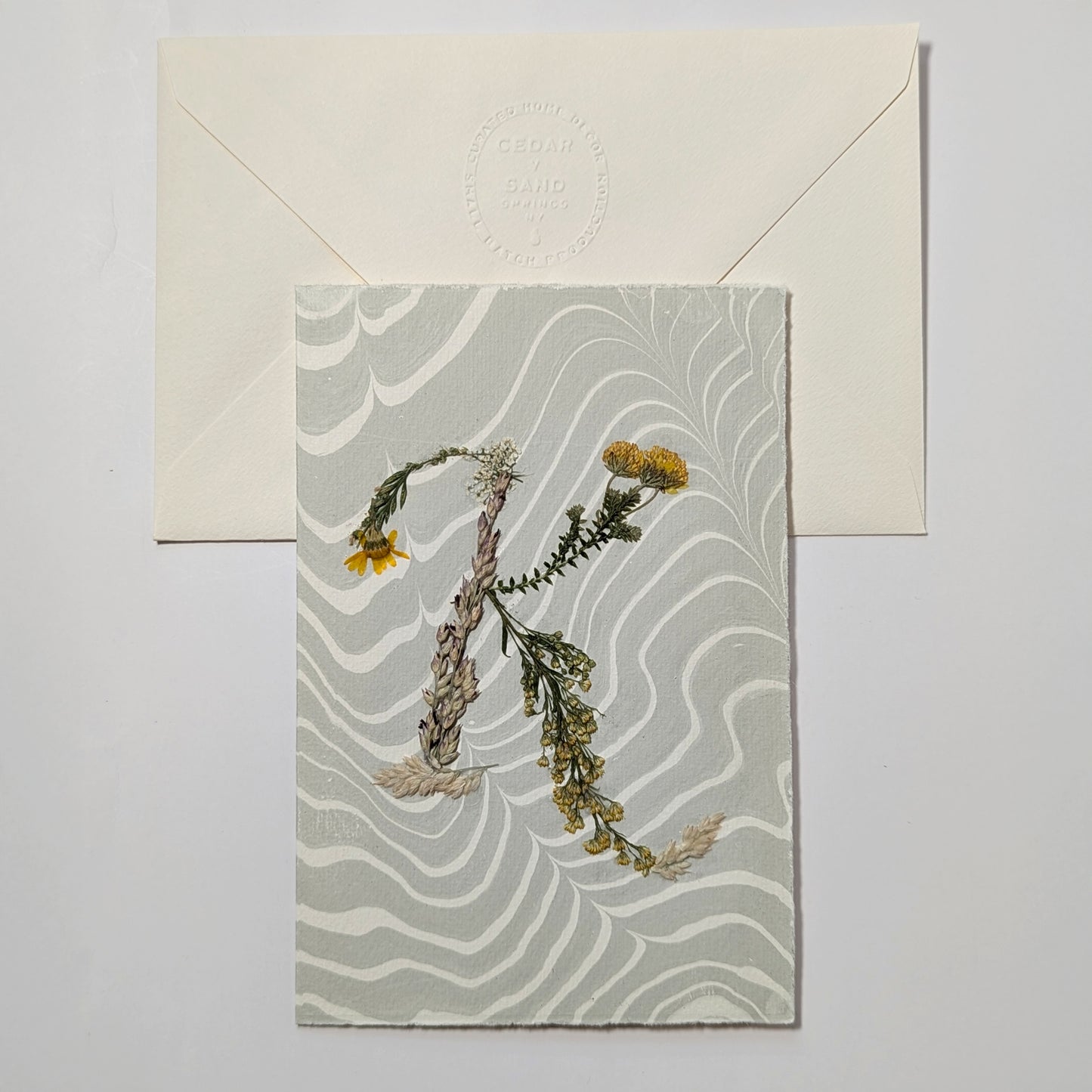Pressed floral letter K notecard on marbled Suminagashi paper with envelope, handmade botanical stationery