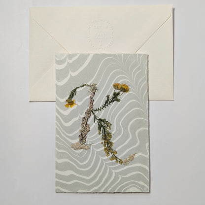 Pressed floral letter K notecard on marbled Suminagashi paper with envelope, handmade botanical stationery