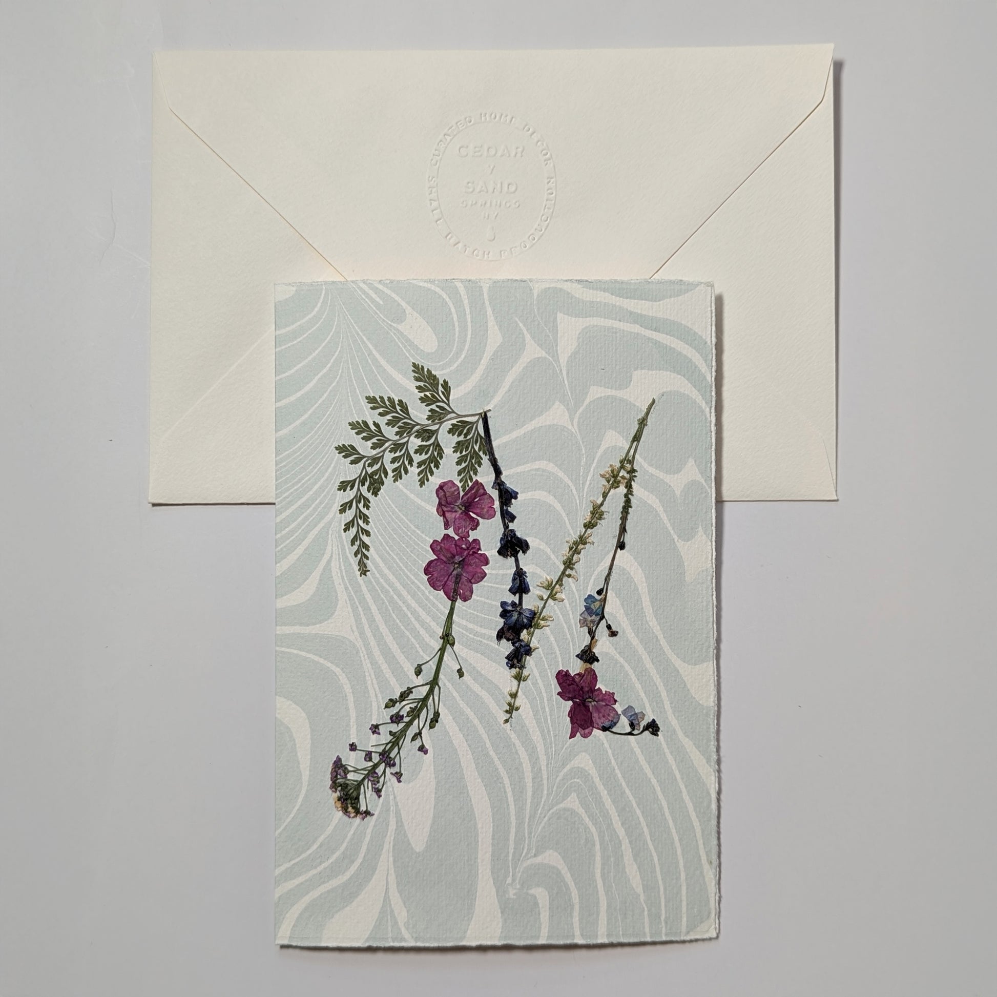 Pressed flower letter M notecard on pale blue Suminagashi paper with envelope, handmade botanical initial card