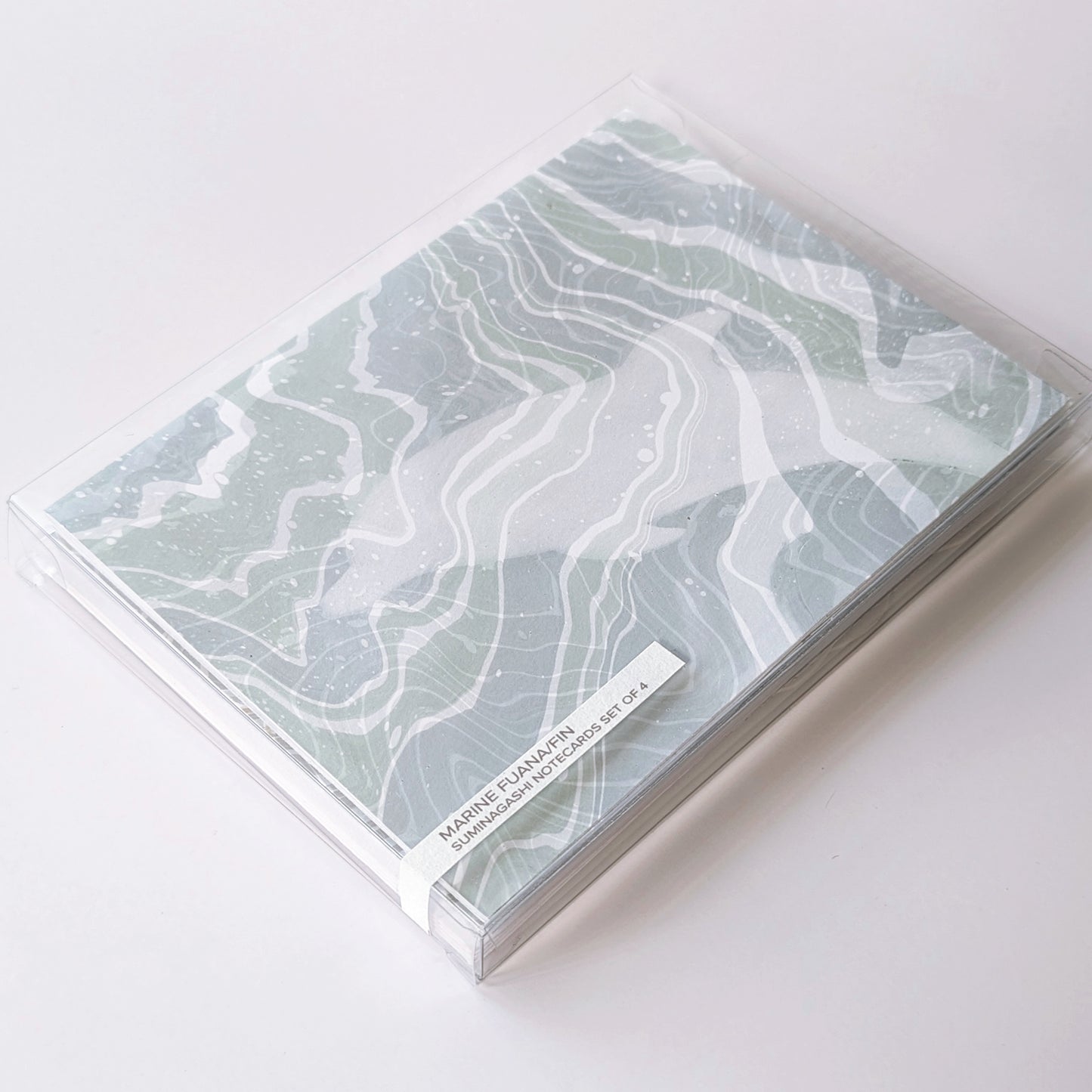Marine Fauna Fin Series notecard set of four packaged in a clear plastic box with visible marbled dolphin design and printed label.