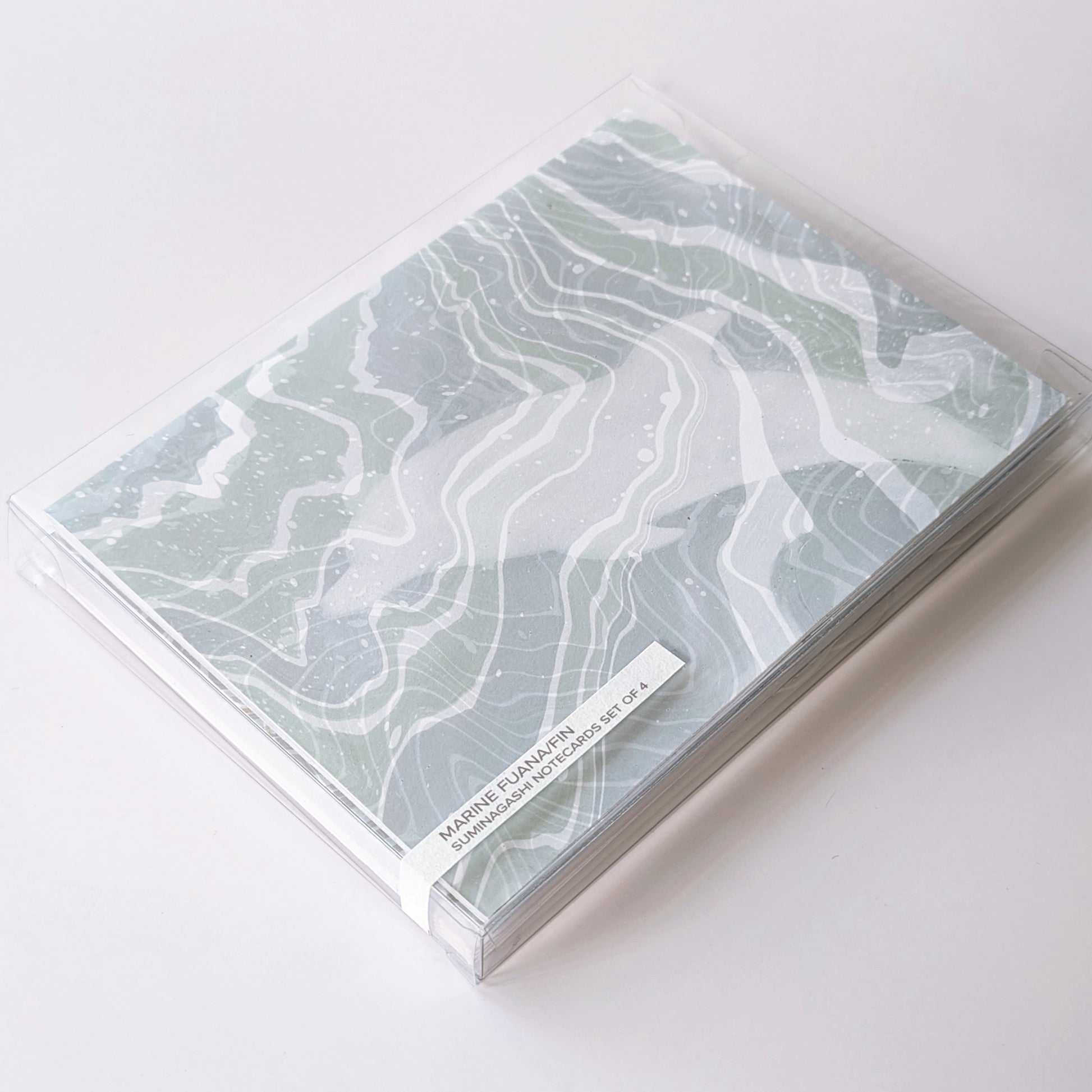 Marine Fauna Fin Series notecard set of four packaged in a clear plastic box with visible marbled dolphin design and printed label.