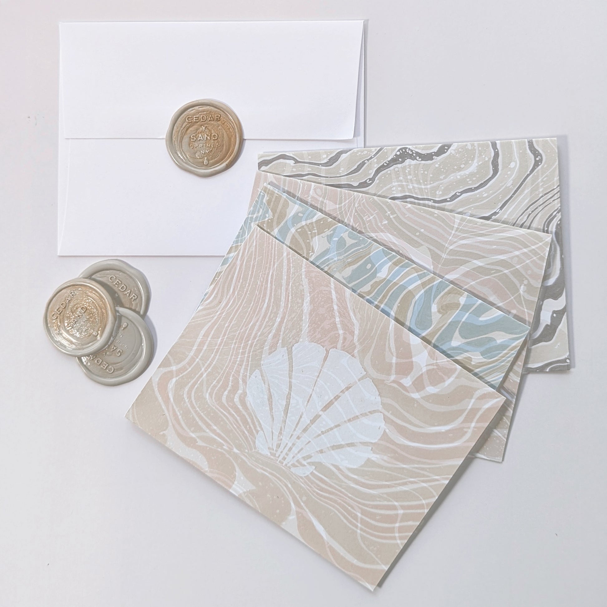 Group photo of Marine Fauna Sea Life notecards with matching envelopes and Cedar Y Sand wax seals.