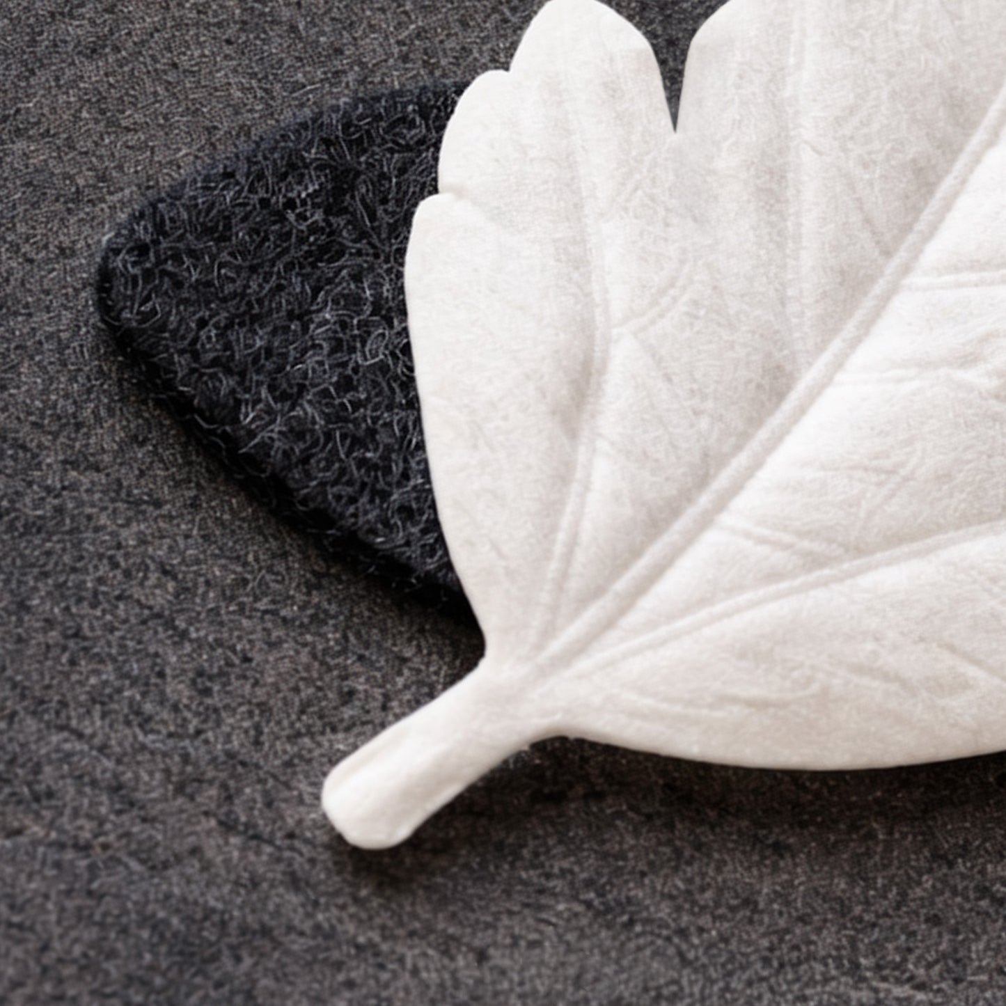 HA KO paper leaf incense resting on black felt burner mat, close-up detail of placement.