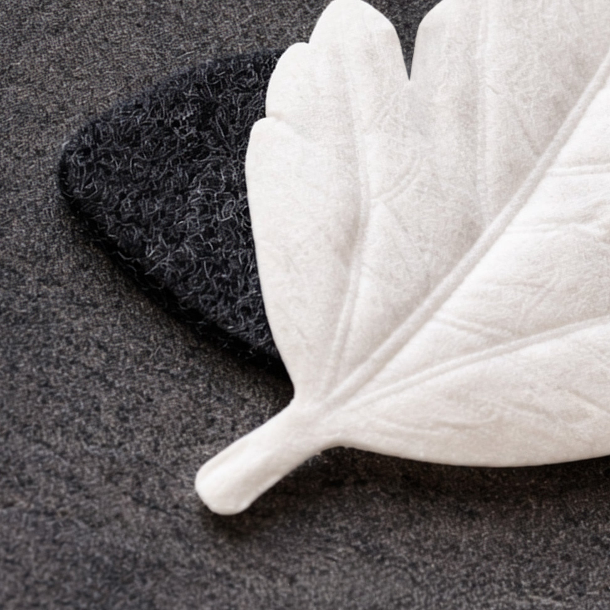 HA KO paper leaf incense resting on black felt burner mat, close-up detail of placement.