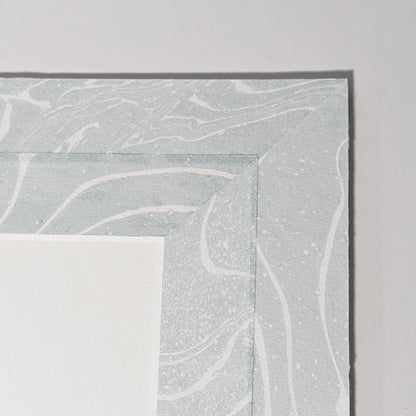 Hand-marbled suminagashi Hosho paper mat detail in soft blue and white swirling patterns