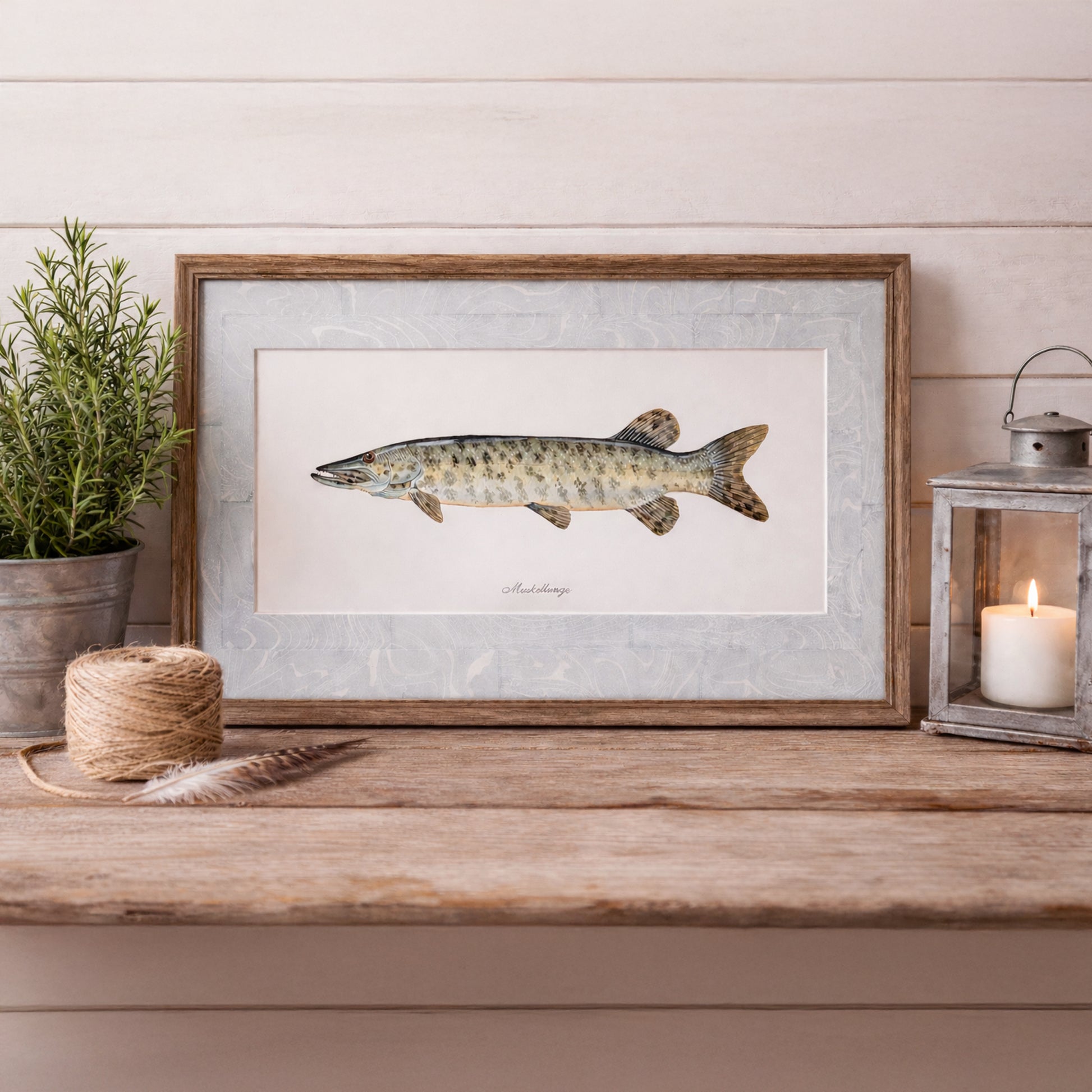 Framed muskellunge watercolor artwork displayed on rustic wood table with coastal decor and candle