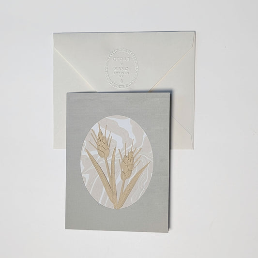 Wheat Paper Botanicals Suminagashi notecard with hand-cut sculpted wheat on a neutral marbled background and embossed envelope.