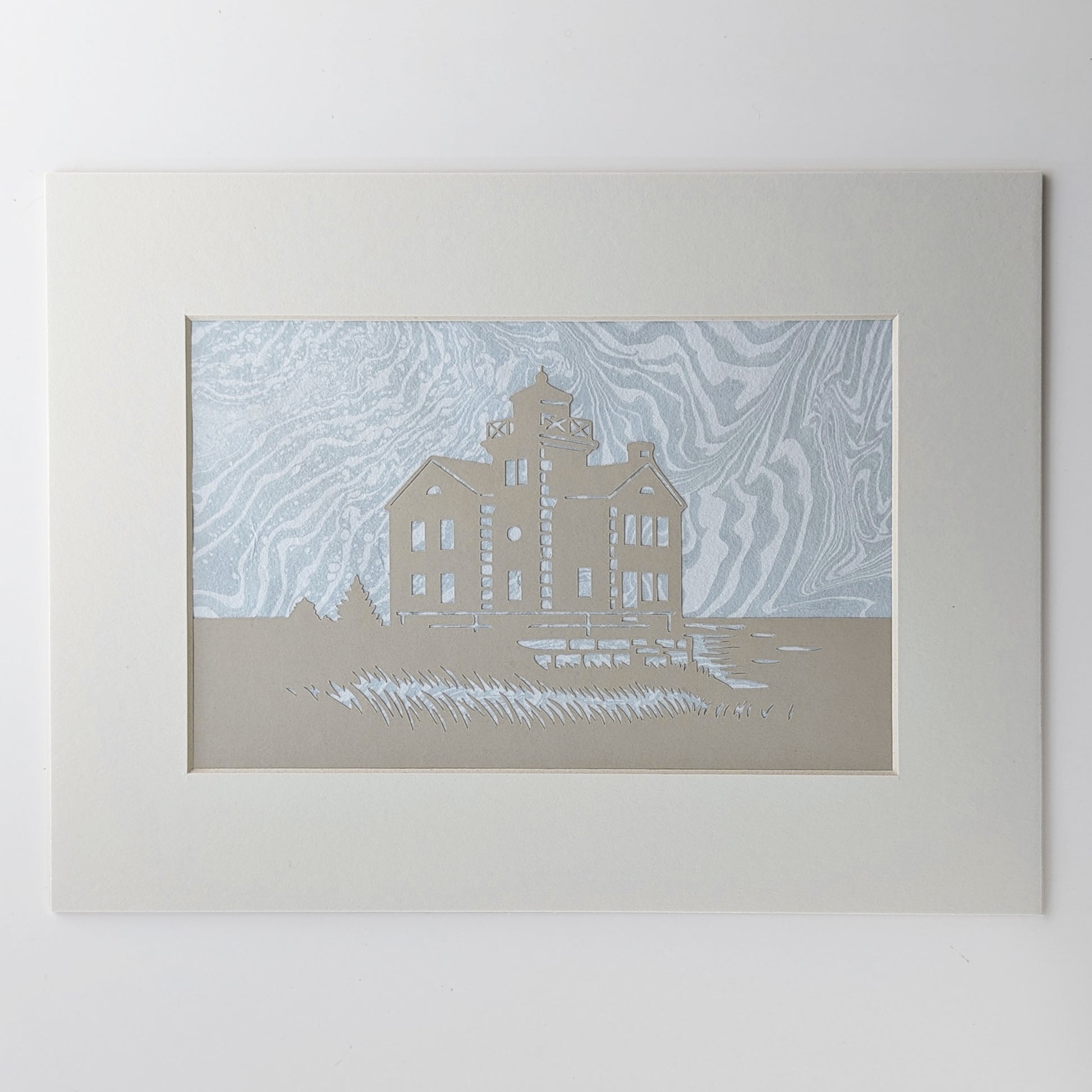 Cedar Point Lighthouse silhouette in dune-toned paper, layered over hand-marbled foggy blue-gray suminagashi background, matted in off white.