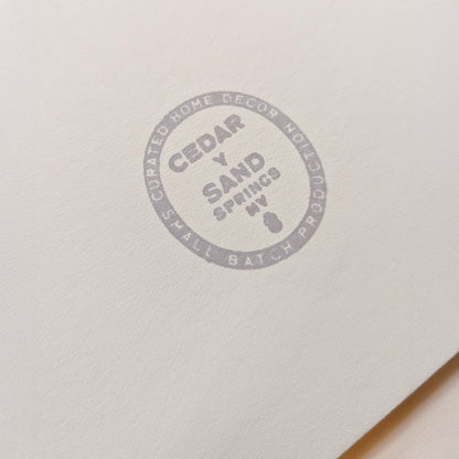 Cedar Y Sand insignia gray back stamp on the backing mat