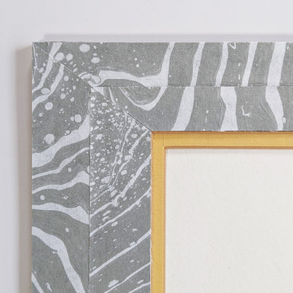 Close-up of corner showing gray suminagashi-marbled Hosho mat, golden inner liner, and clean archival mounting.