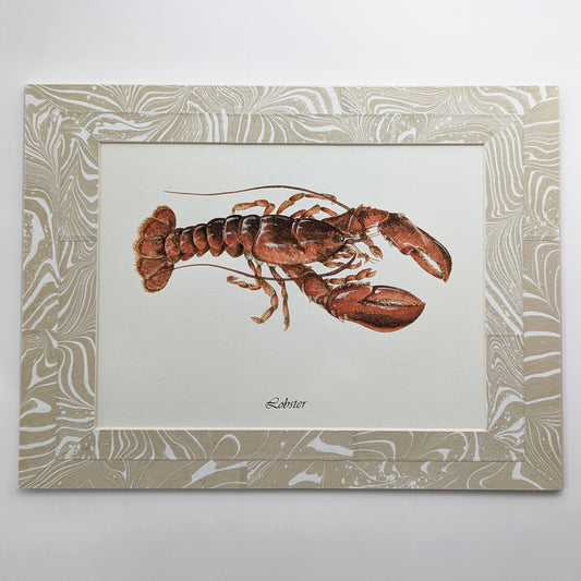 Framed Cooked Lobstah gouache watercolor painting mounted in a tan-white suminagashi marbled mat.