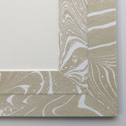 Close view of tan and white suminagashi marbled Hosho paper mat around painting.