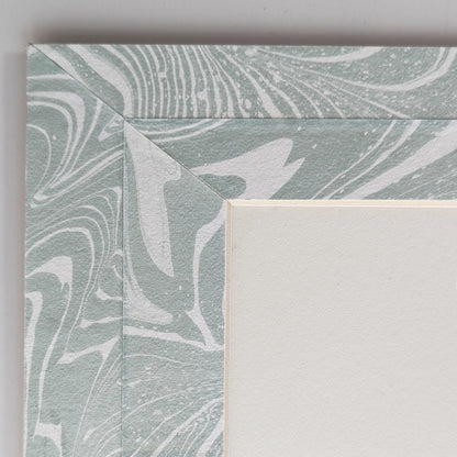Close view of blue-white suminagashi marbled Hosho paper mat around painting.