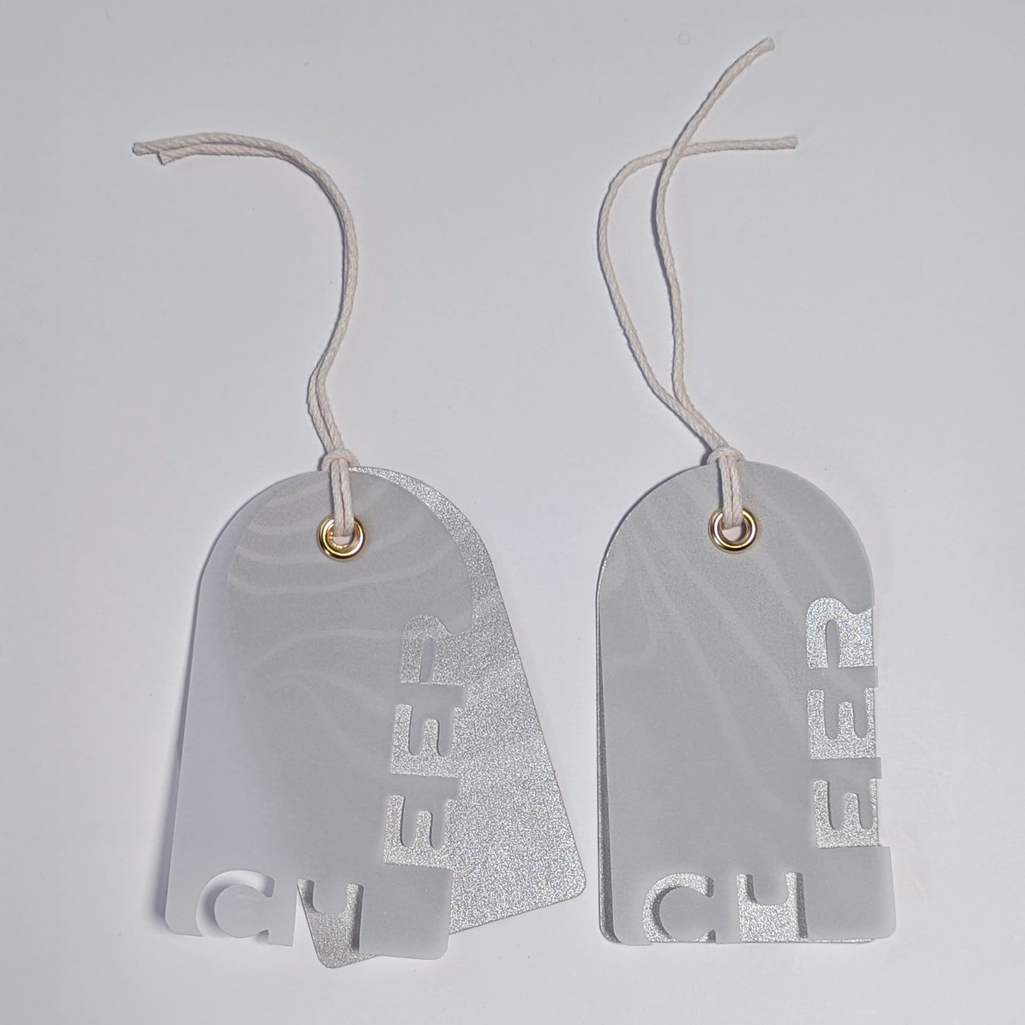 Two CHEER vellum cut-out gift tags layered over silver-toned Suminagashi marbled backings.